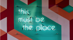 A sign that reads "this must be the place"