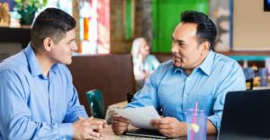 Two men in an interview at a restaurant
