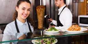 A man and woman smiling in a restaurant