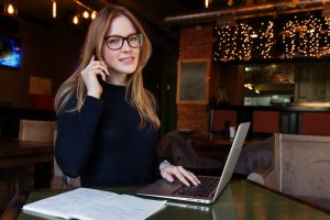 A woman on a laptop researching management styles