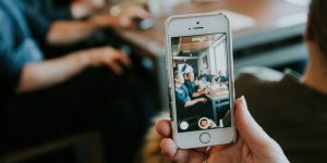 Someone holding a phone and using video for recruitment