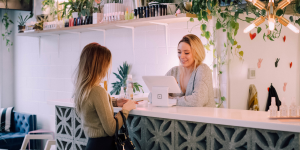 A woman talking to a front-desk employee