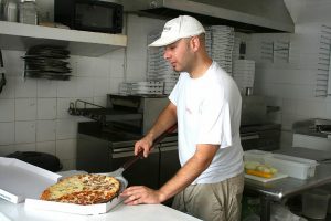 A man in a pizza shop