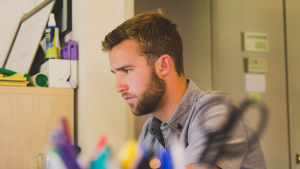 A man on the computer researching employee discipline practices