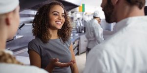A smiling woman explaing the importance of cultural fit for restaurant employees