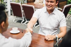 Two men shaking hands at a restaurant