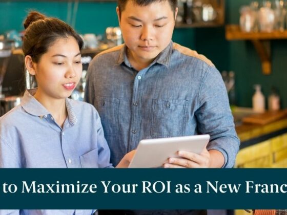 A man and woman looking at a tablet and text reading "How to Maximize Your ROI as a new Franchisee"