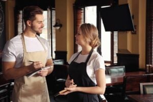 Two people working at a restaurant franchise location