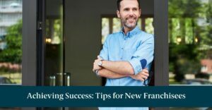 A new franchisee standing outside of his building and smiling