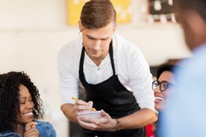 A waiter providing good customer service