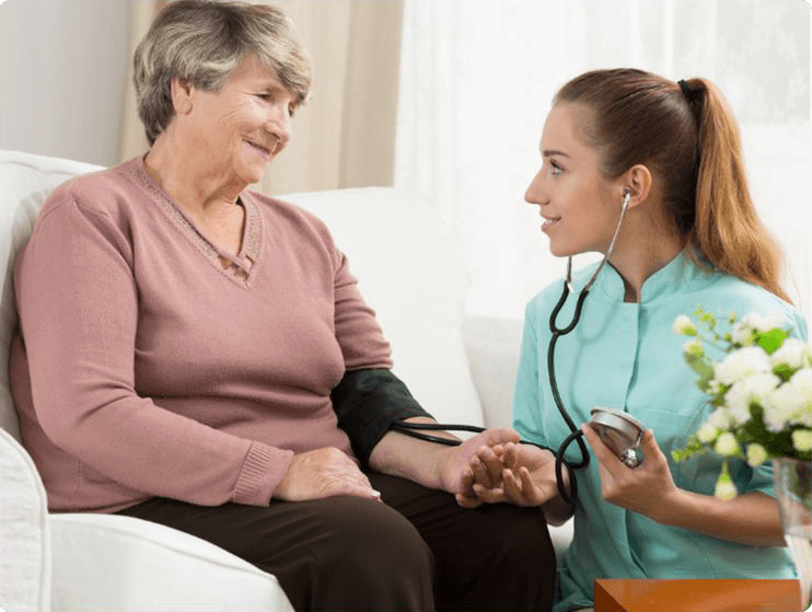 A nurse checking a patients blood pressure